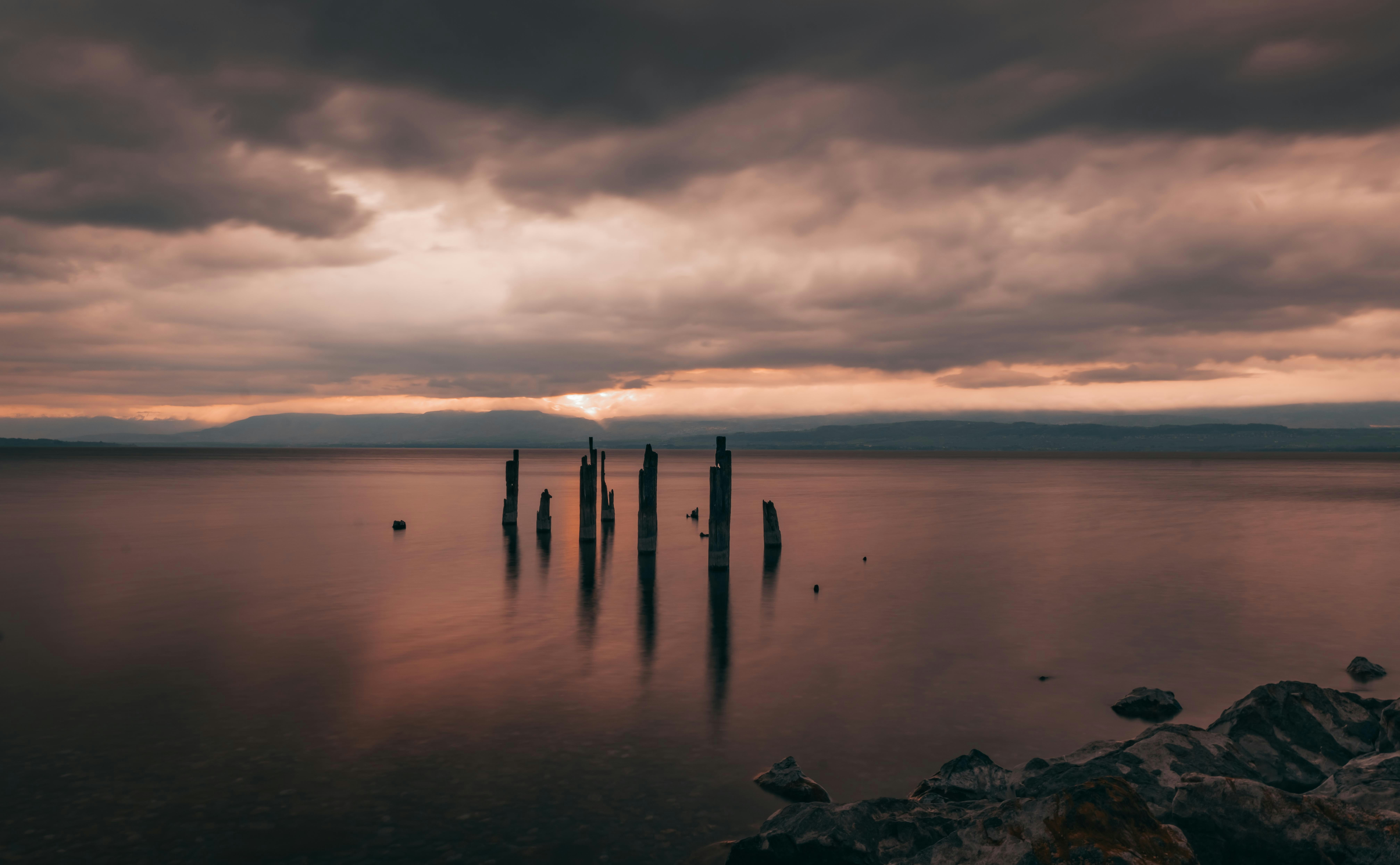 a body of water with a bunch of poles sticking out of it