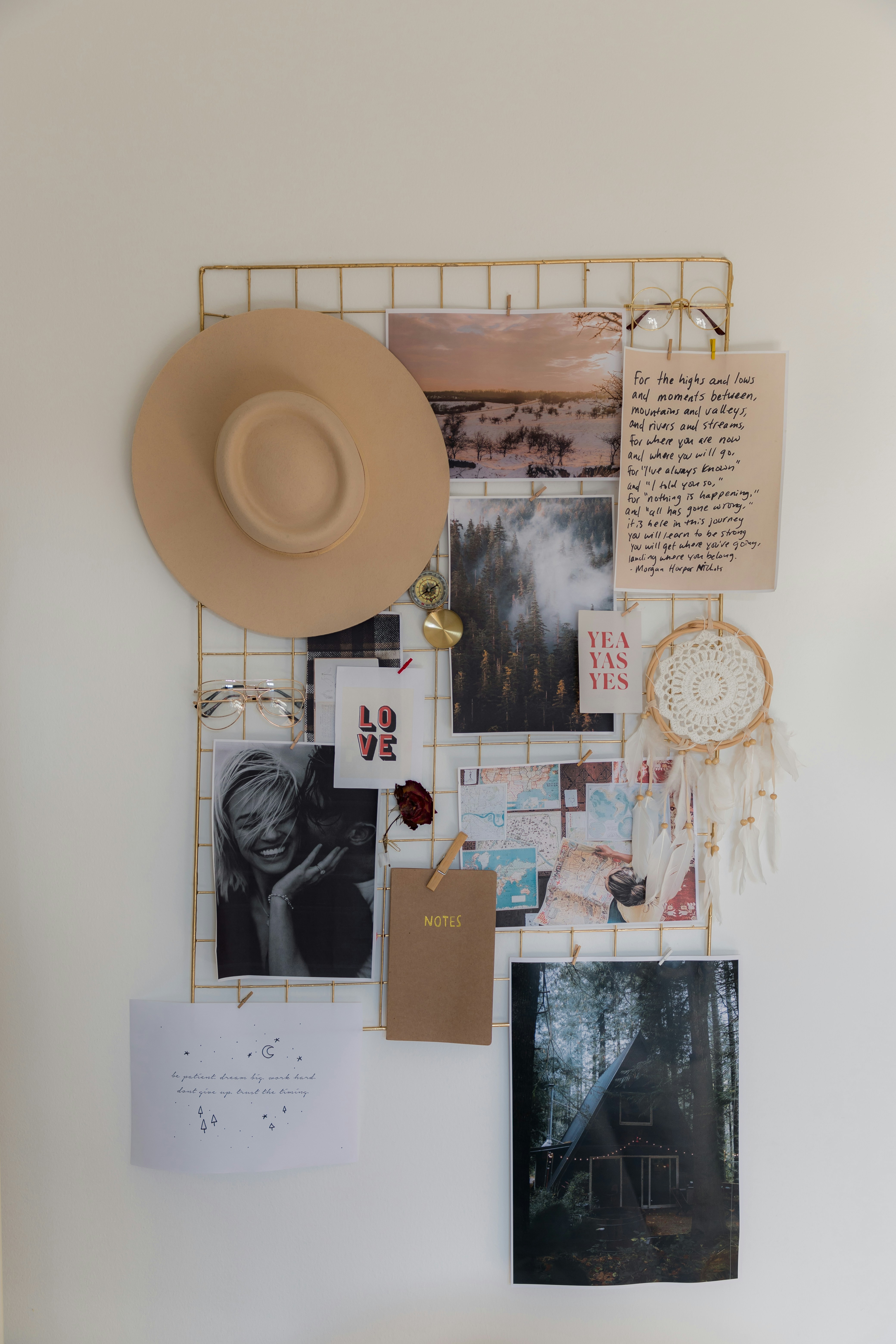 a white wall with a hat and pictures on it
