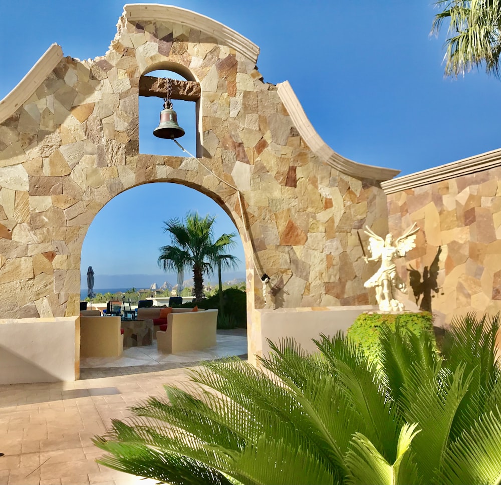 a stone archway with a bell on top of it