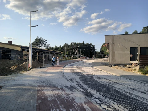 A community working together to build a new village road under clear skies.