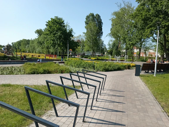 A wide-angle shot of a well-maintained park with jogging paths and families relaxing