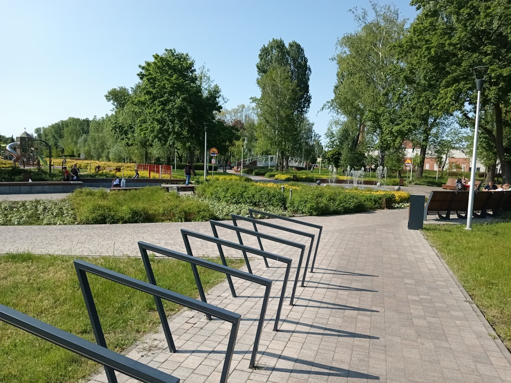 a row of benches sitting on top of a brick walkway