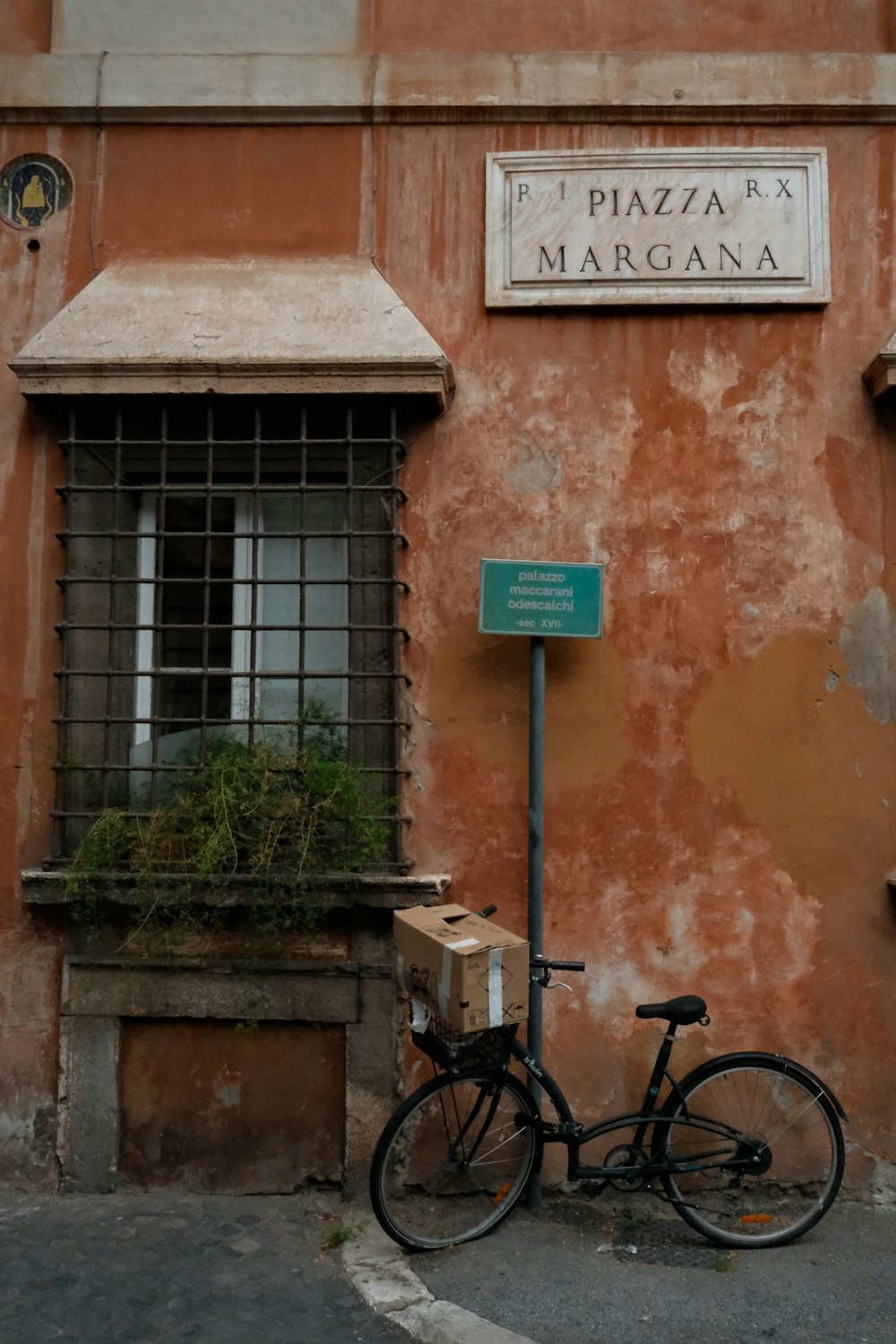 a bike parked next to a building with a sign on it