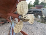 Technician installing a new yacht propeller in a sunny dockside setting.