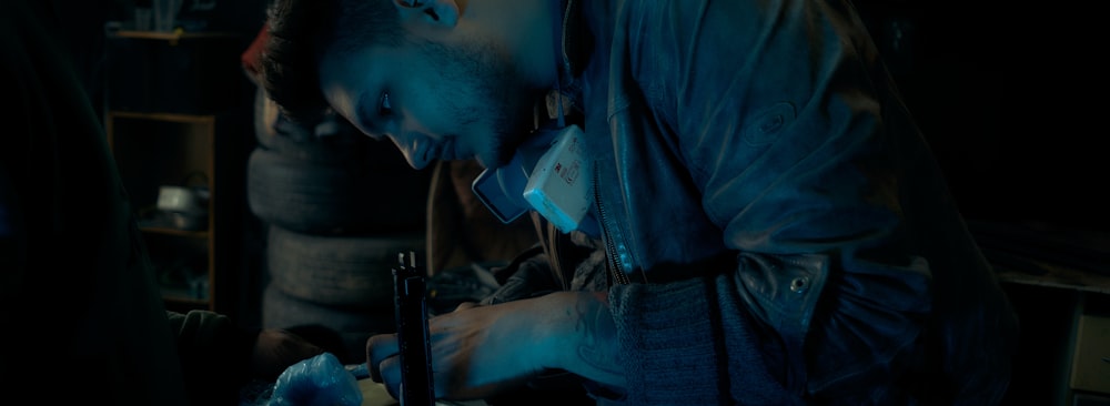 a man working on something in a dark room