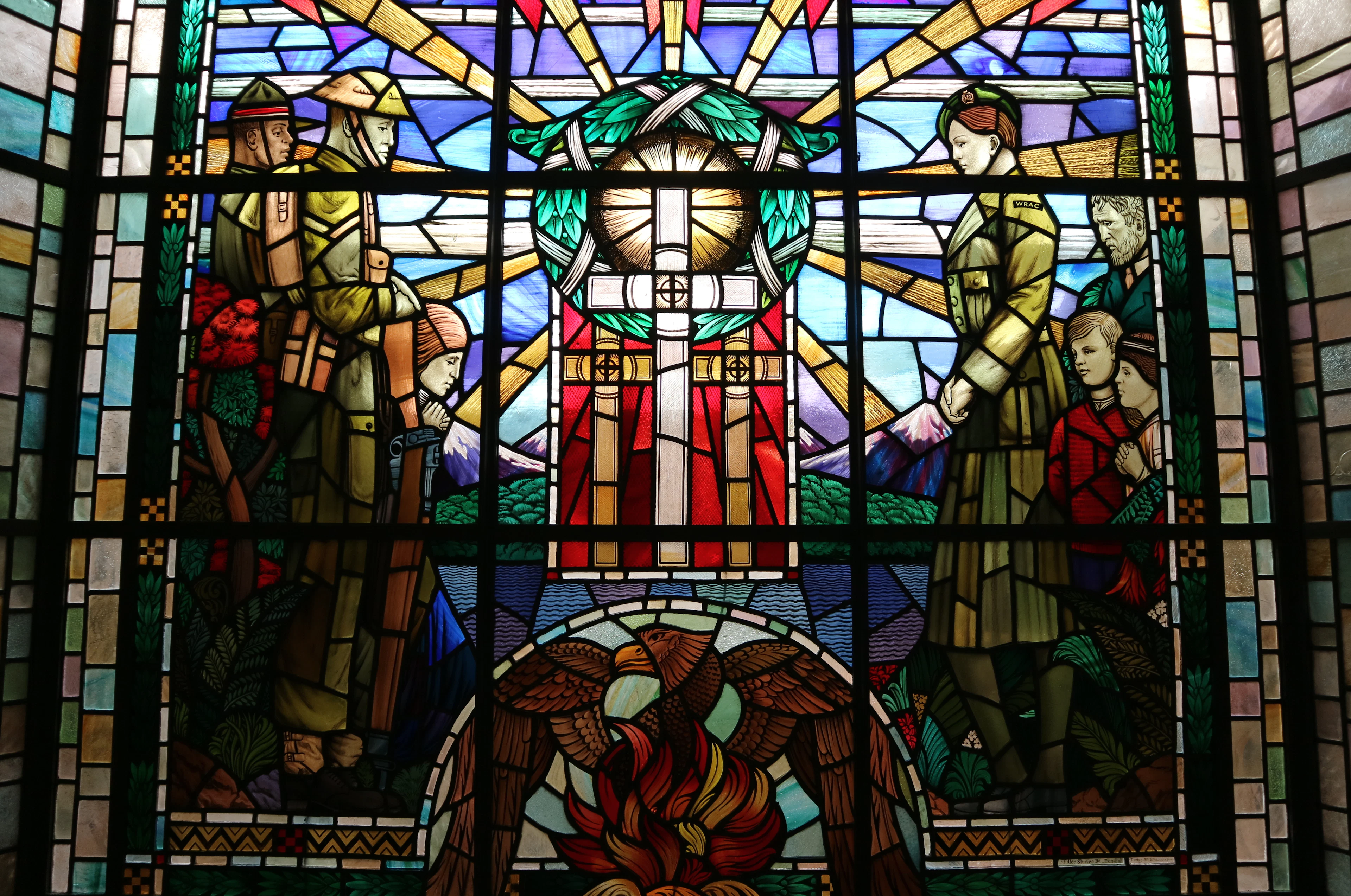 A stained-glass memorial window inside Auckland War Memorial Museum depicting soldiers in a wartime scene.