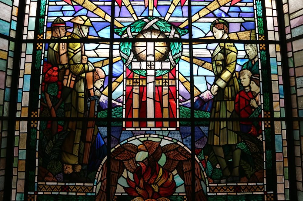 a stained glass window with a statue of jesus