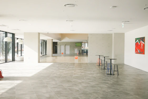 A sleek, modern interior showcasing minimalist design with black, light gray, and orange accents.