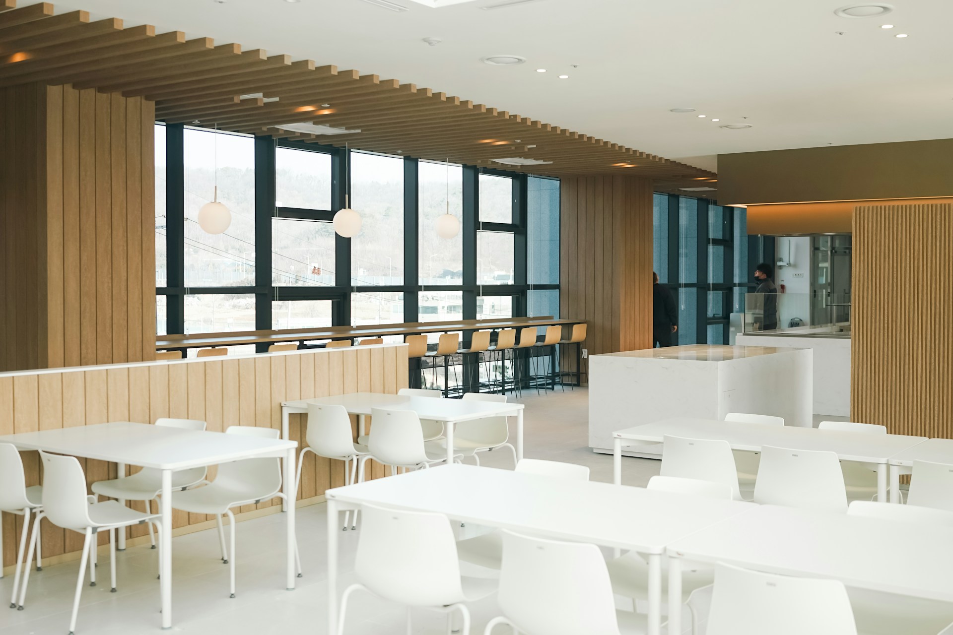 a room with tables and chairs and a bar