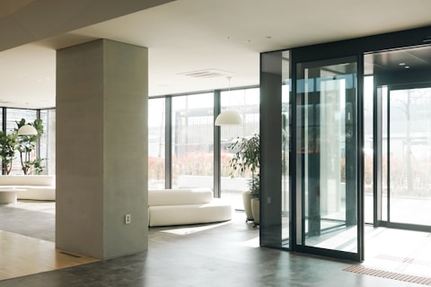 a living room with a lot of glass doors