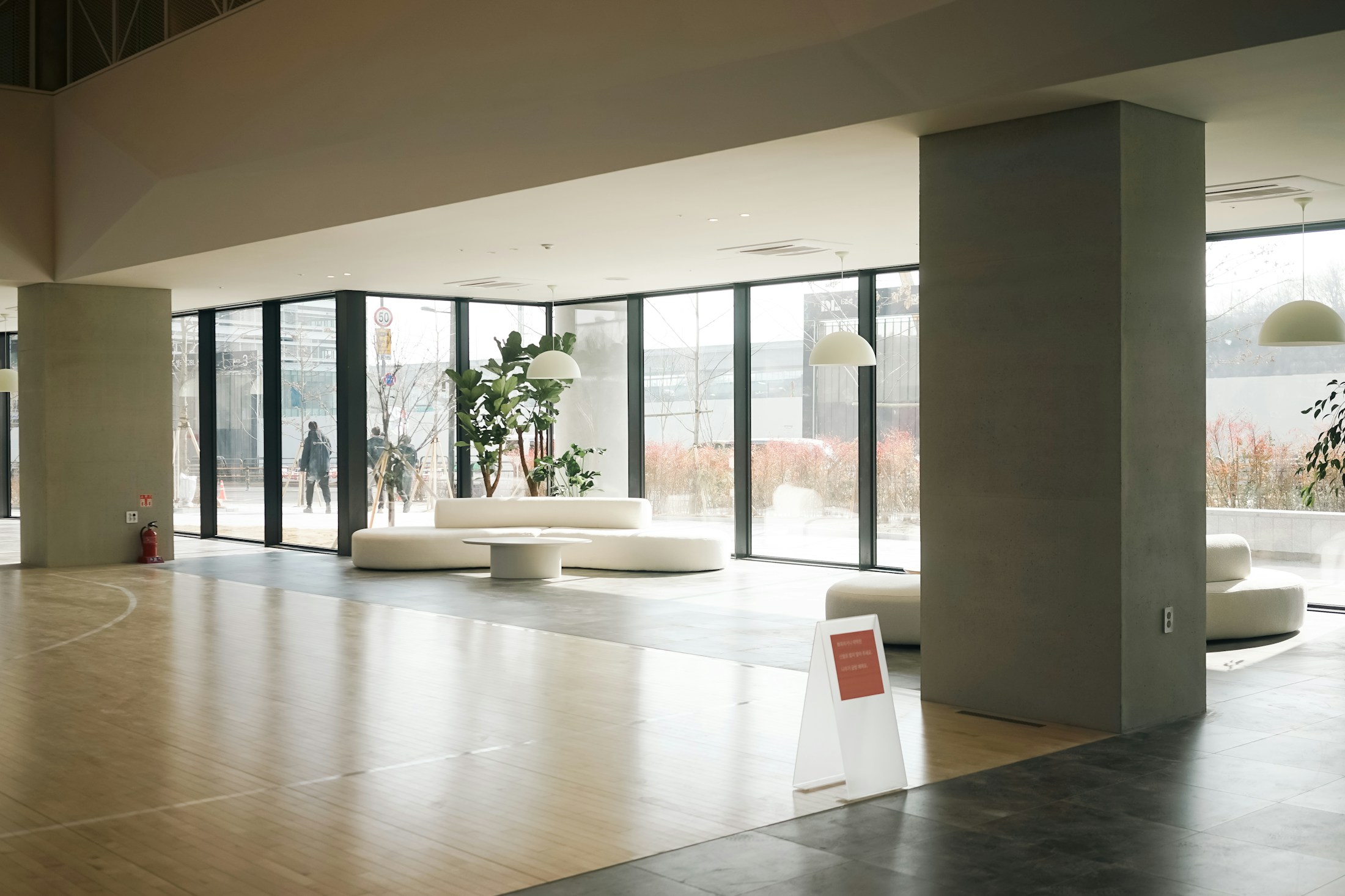 Commercial lobby with a wide plank and stone floor running the length of the space