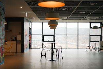 a room that has a lot of chairs and tables in it