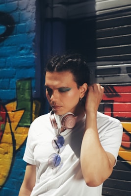 A close-up of a model wearing a graphic tee paired with headphones, blending music and fashion.