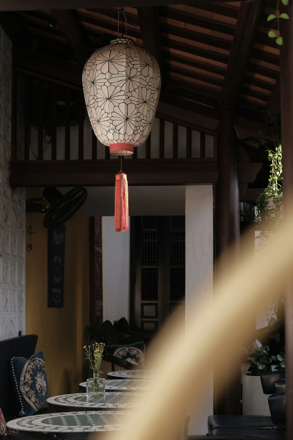 a dining room with a table and chairs and a lantern hanging from the ceiling