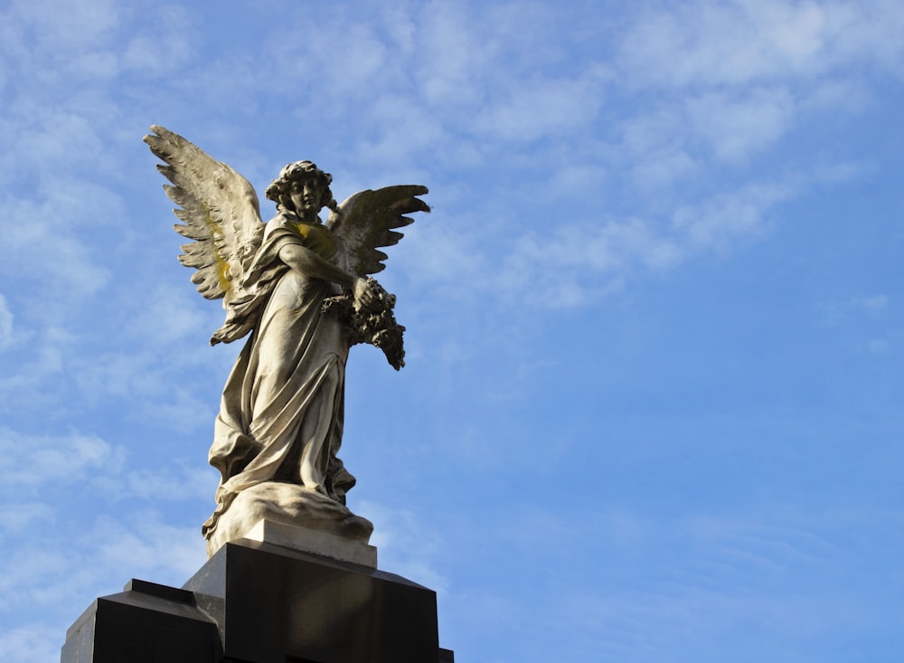 a statue of an angel on top of a building