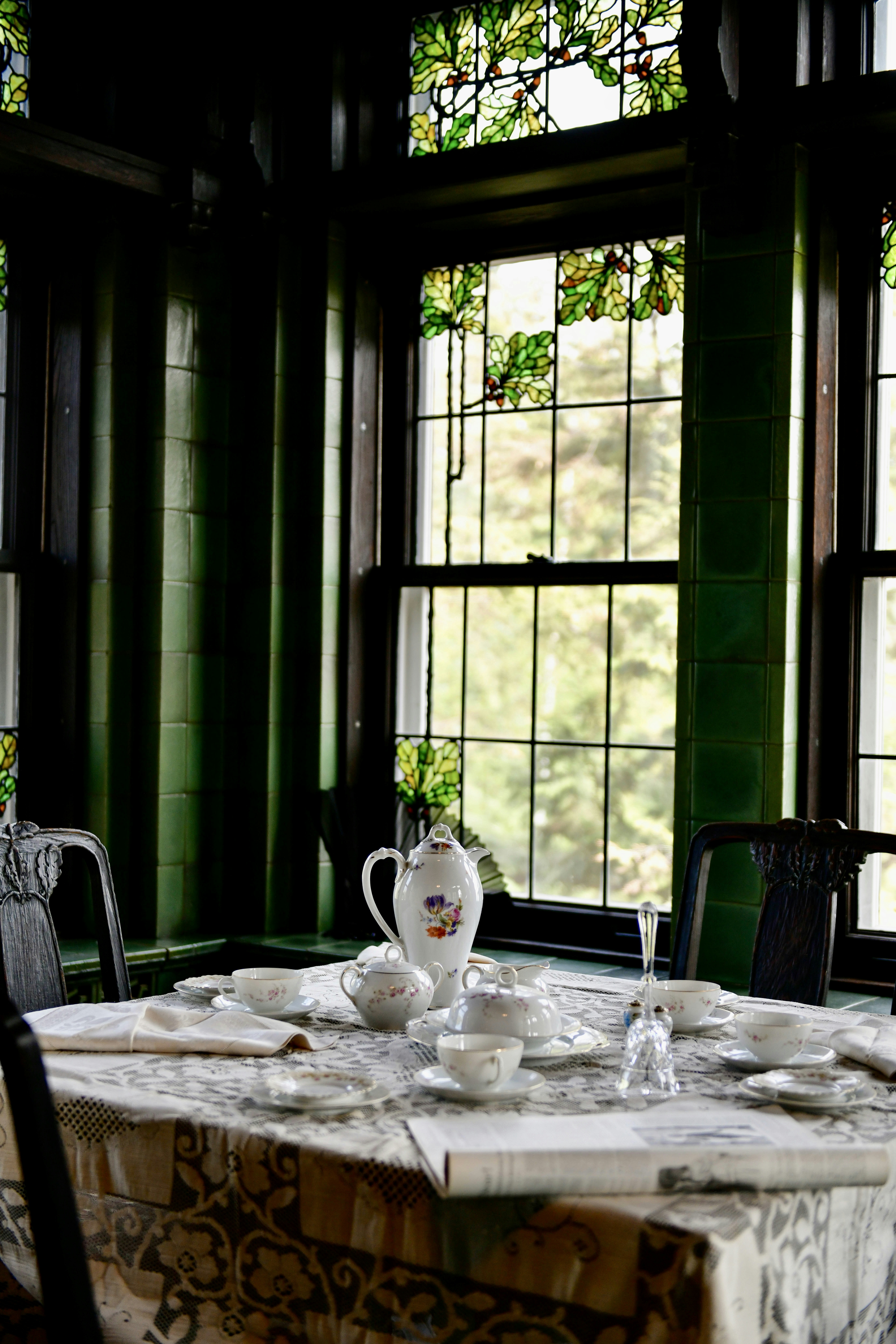 a table with a white table cloth on it in front of a window
