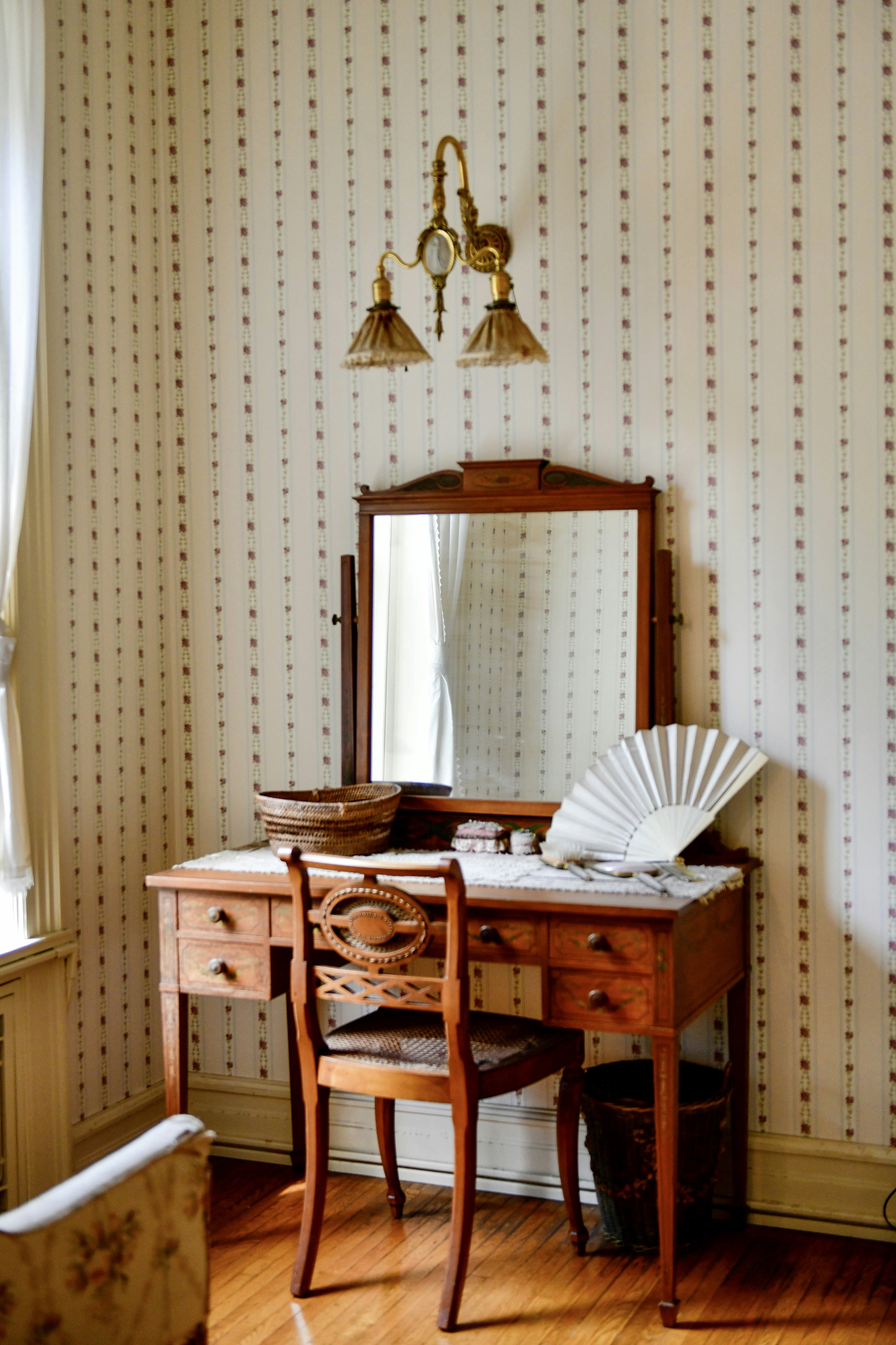 a desk with a mirror and a fan on top of it