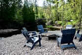 a group of chairs sitting around a fire pit
