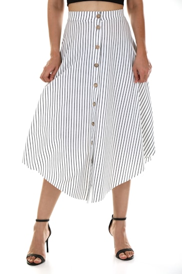 A person is wearing a vertically striped, button-down skirt with a black top. The skirt is white with black stripes and features several buttons down the front. The person is also wearing black high-heeled sandals.
