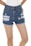 Blue denim shorts with frayed edges and distressed detailing. A white shirt is partially visible at the top, and bare legs are prominent in the image.