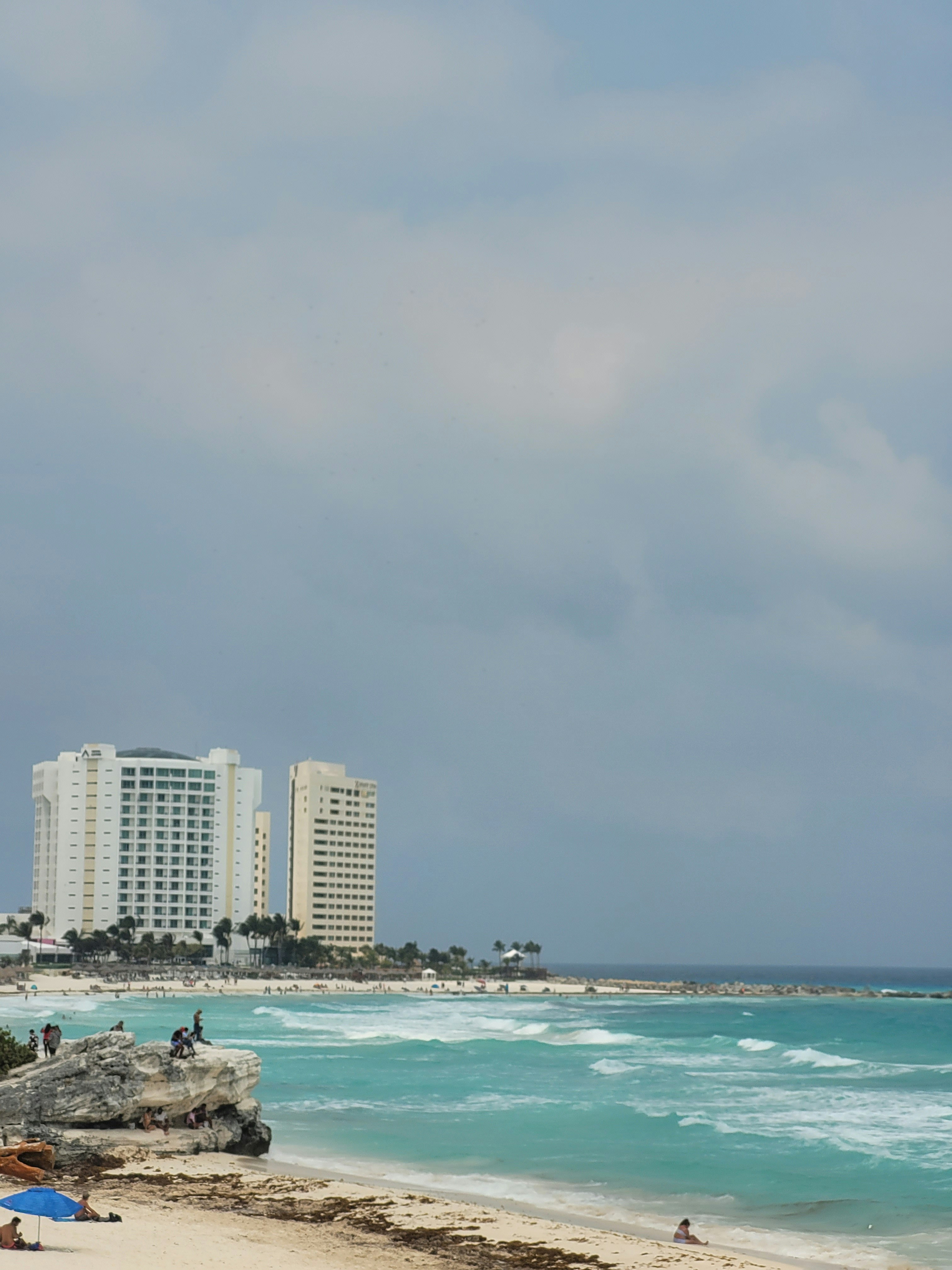 a sandy beach with a few people on it