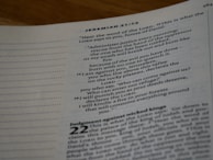 A close-up view of a page from a book, specifically a page of text from the Bible. The page displays text from Jeremiah 21:12 and discusses themes of justice, punishment, and prophecy. The top left corner shows the book name and chapter in bold letters.