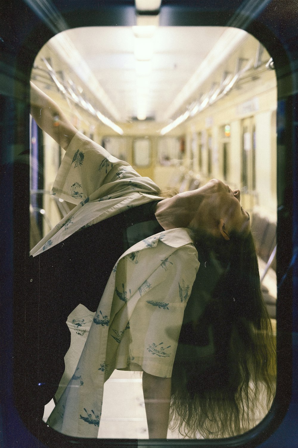 a woman laying down on a subway train