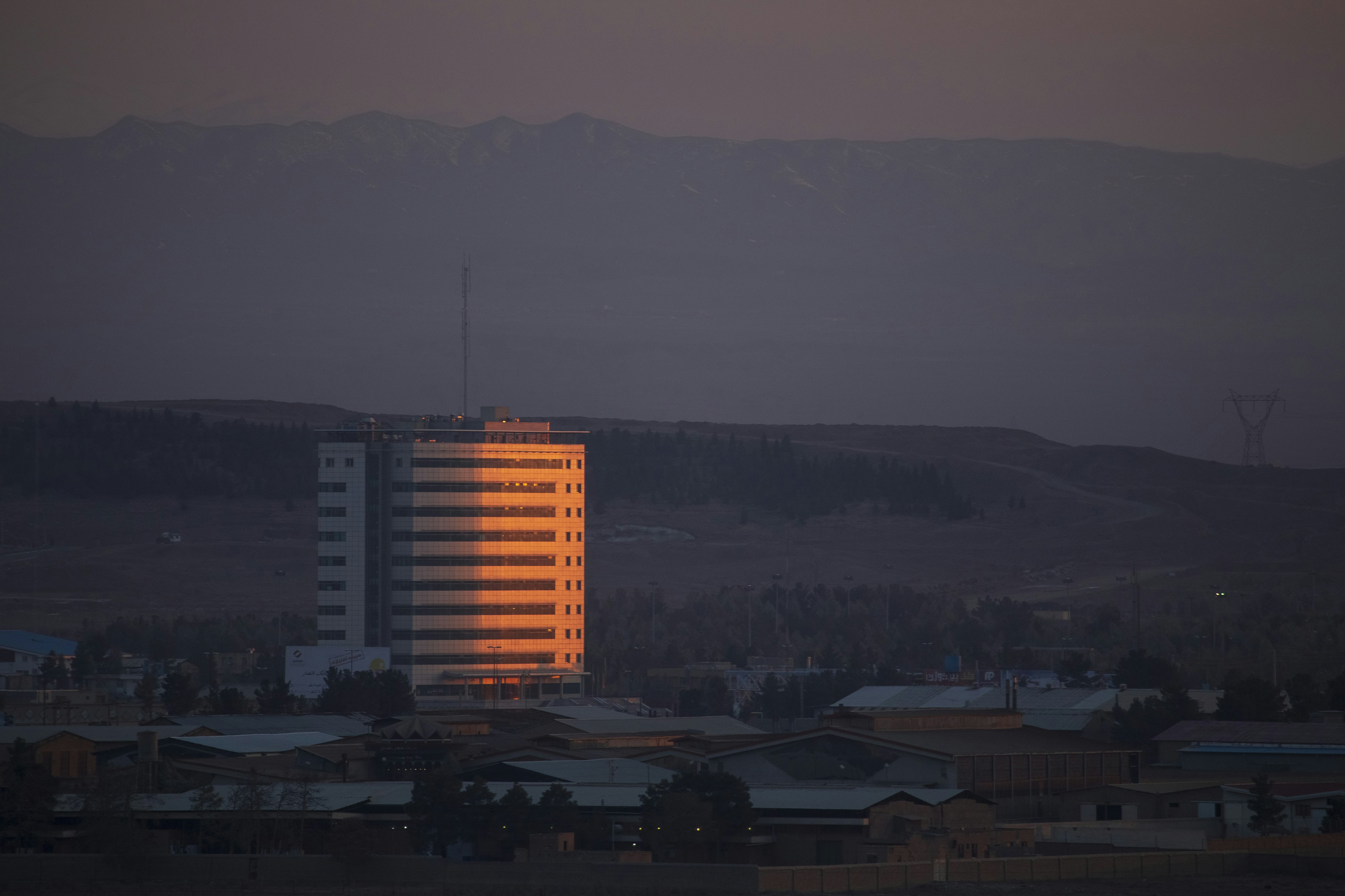 a tall building sitting in the middle of a city