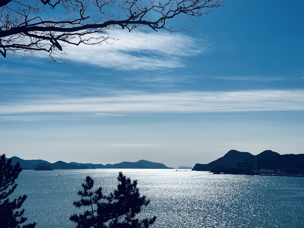 a view of a body of water with mountains in the background