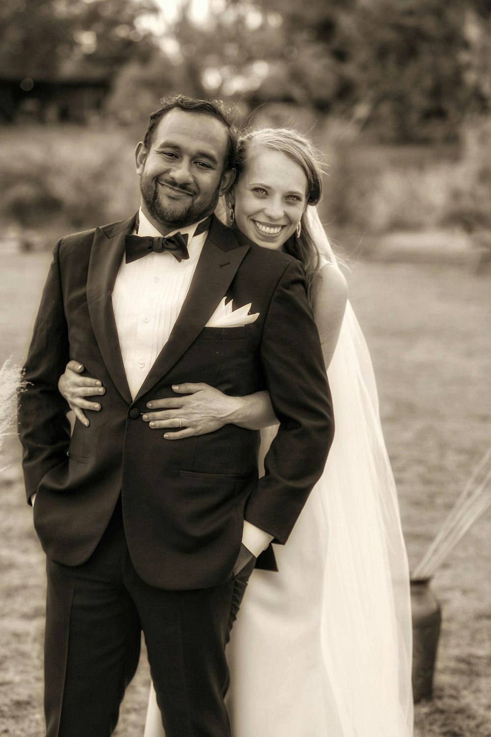 a bride and groom pose for a picture