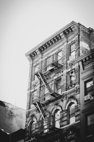a black and white photo of a building with a fire escape