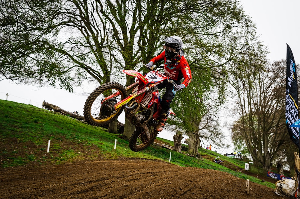 a man riding a dirt bike on top of a dirt field