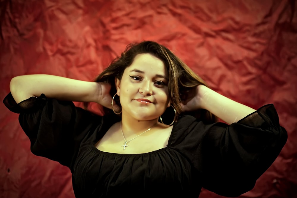 a woman in a black top posing for a picture