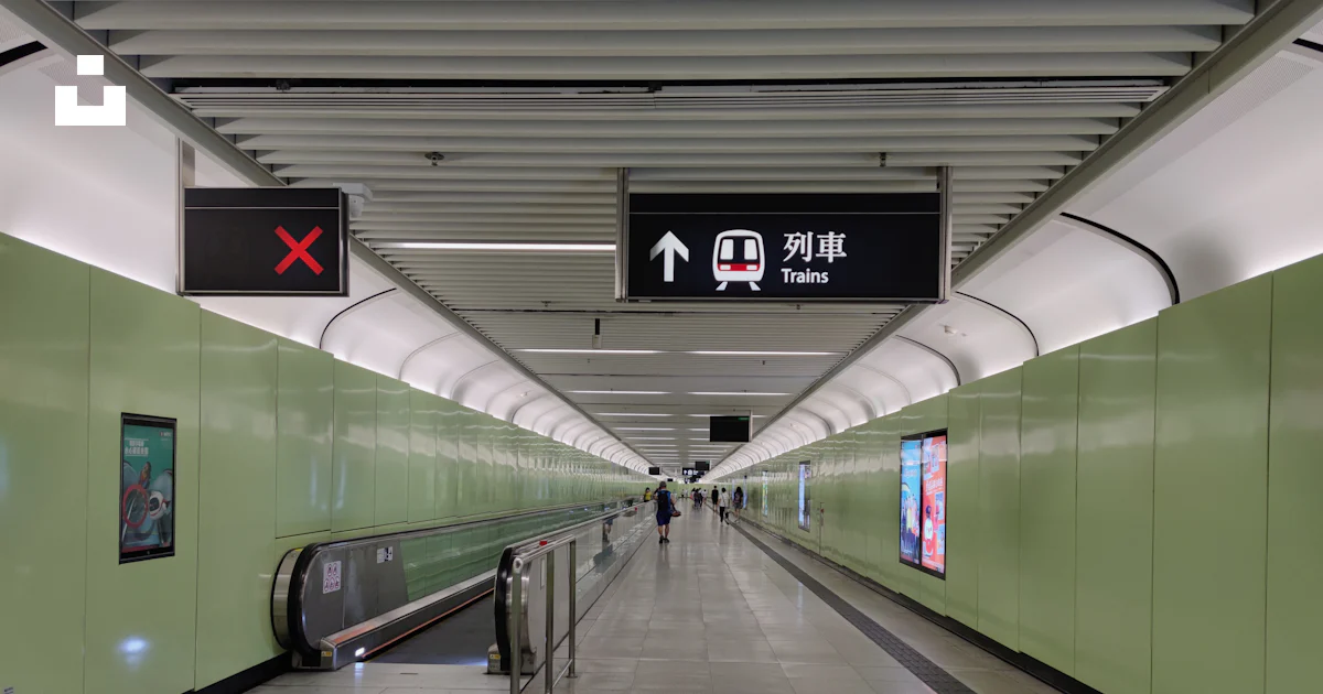 A subway station with a green wall and stairs photo – Free Mtr station ...