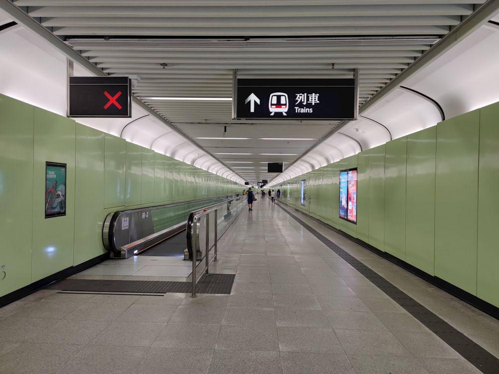 a subway station with a green wall and stairs