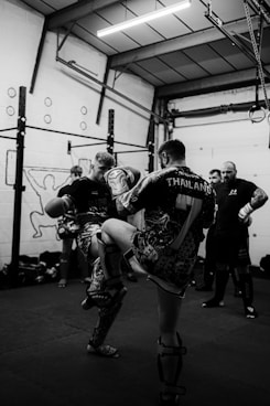 a group of people standing around a gym