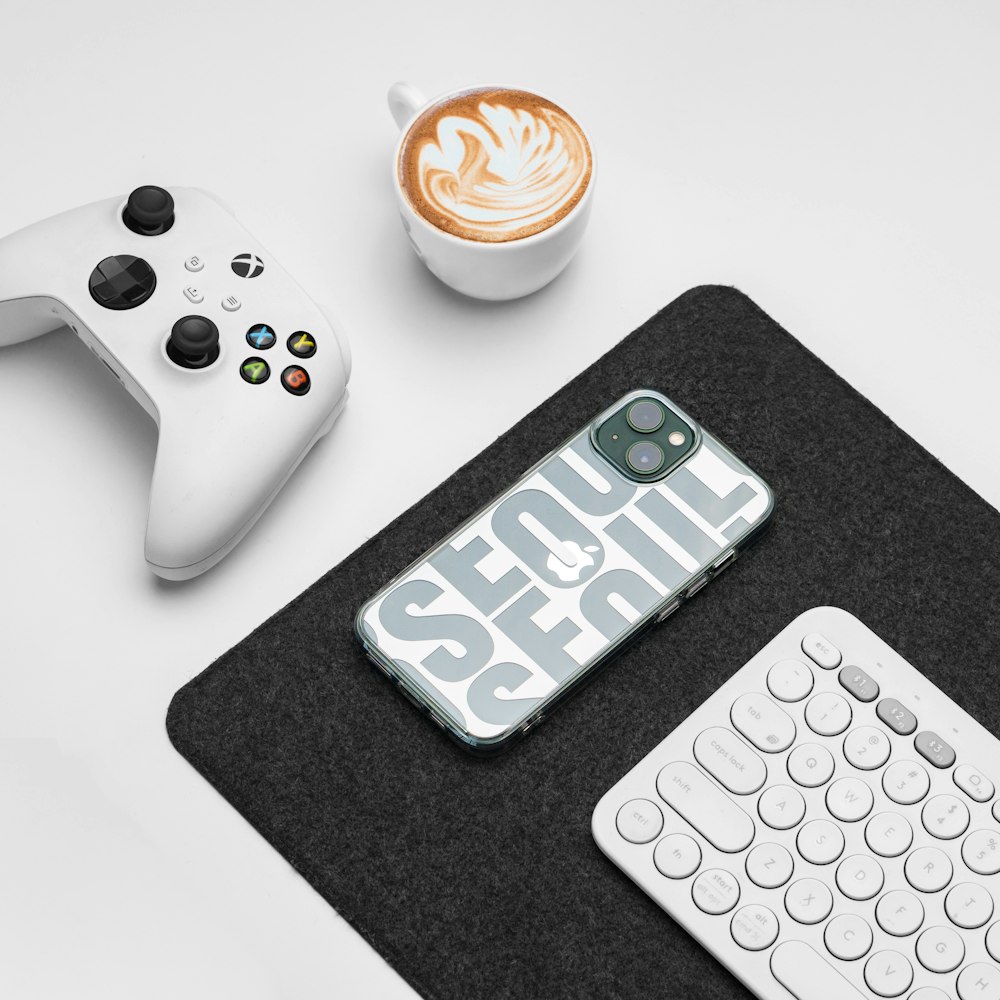 a phone case with the word social on it next to a keyboard and a cup