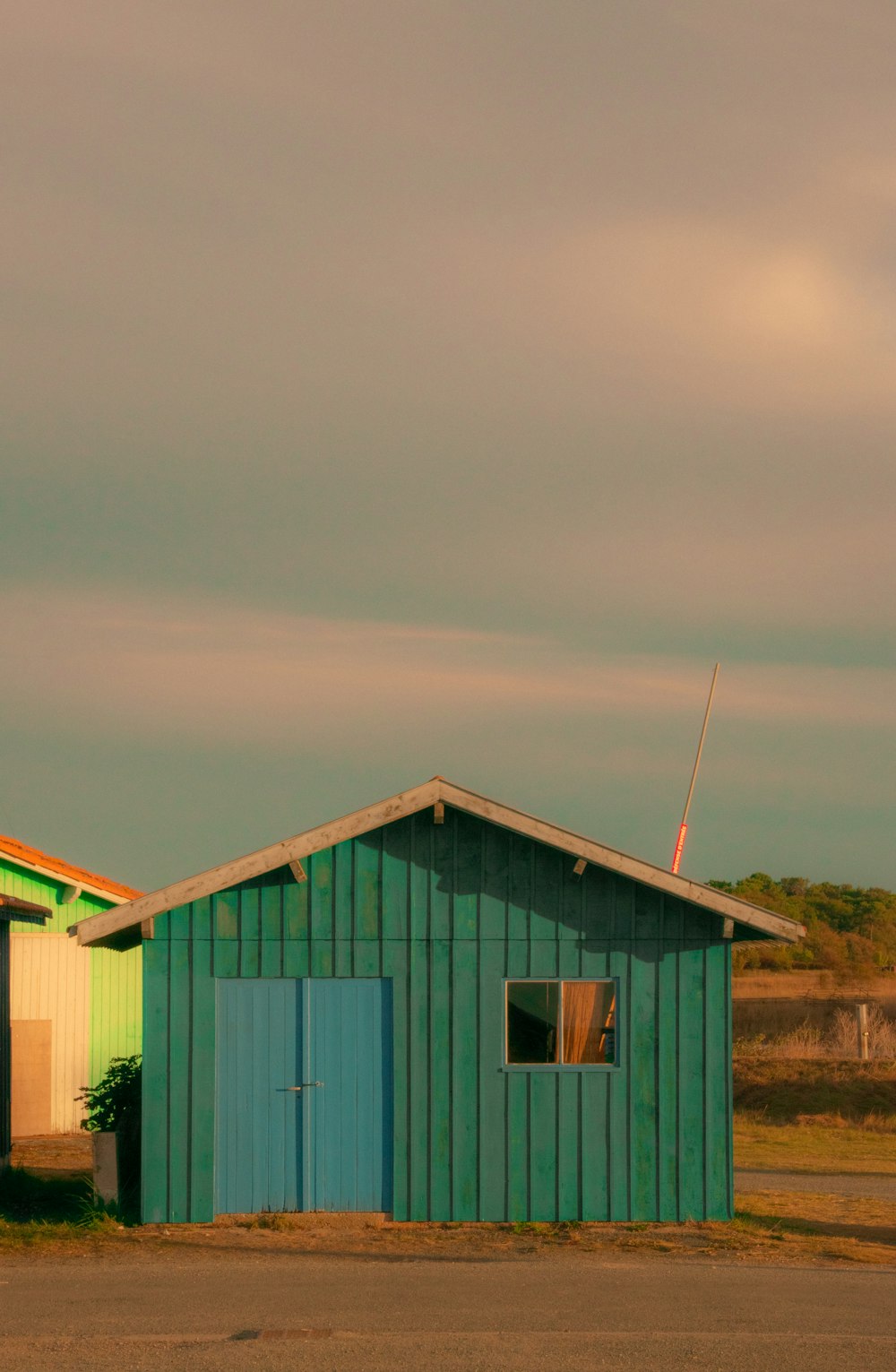 a couple of green buildings sitting next to each other