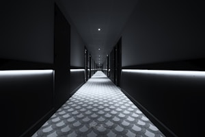 a long hallway with lights on either side of it