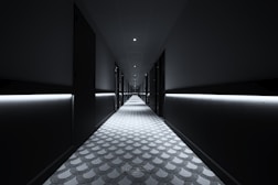 a long hallway with lights on either side of it
