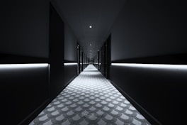 a long hallway with lights on either side of it