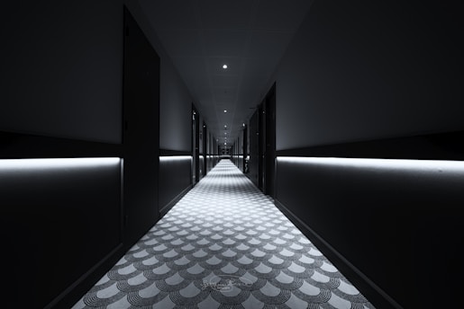 a long hallway with lights on either side of it