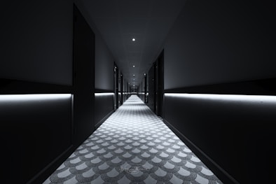 a long hallway with lights on either side of it