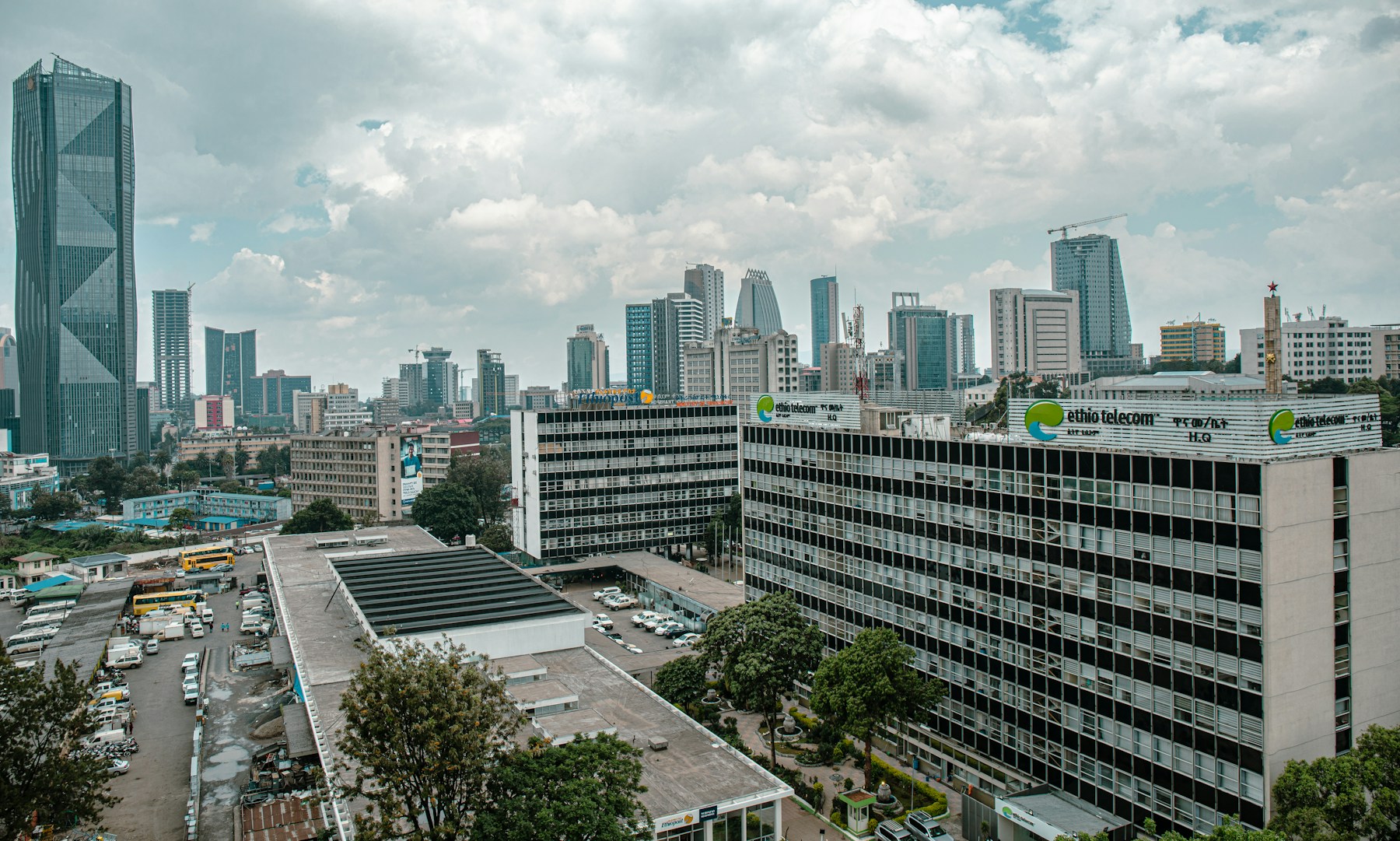 Addis Ababa buildings and distant city streets beneath a cloudy sky.