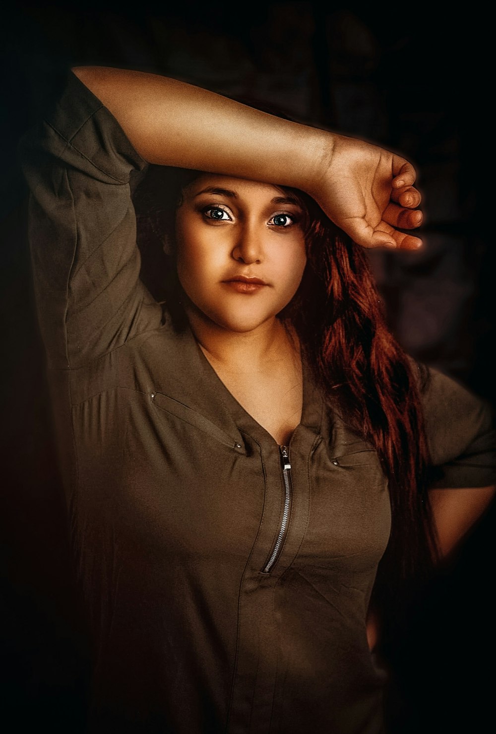 a woman with red hair is posing for a picture