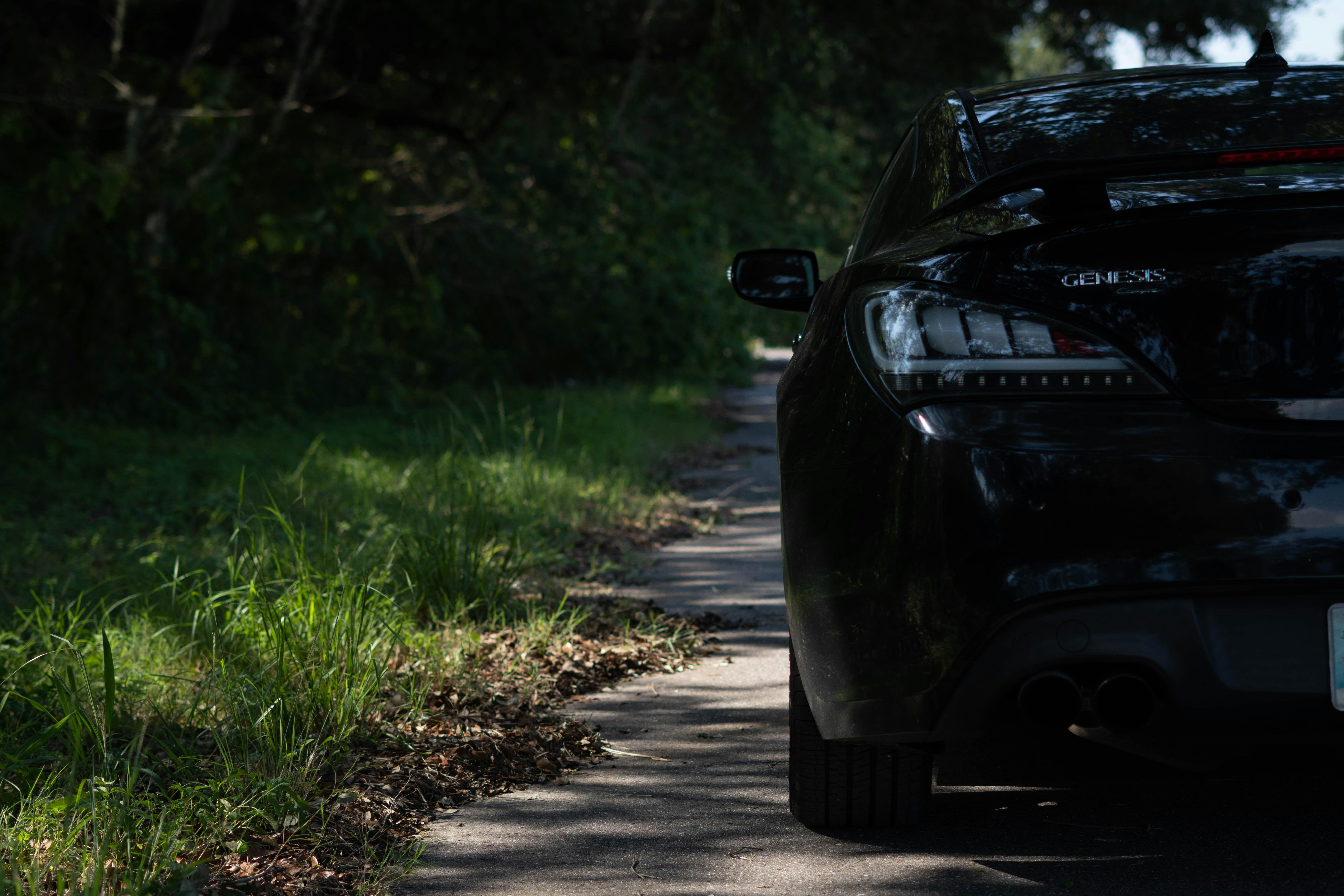 A black car parked on the side of a road photo Free Thonotosassa