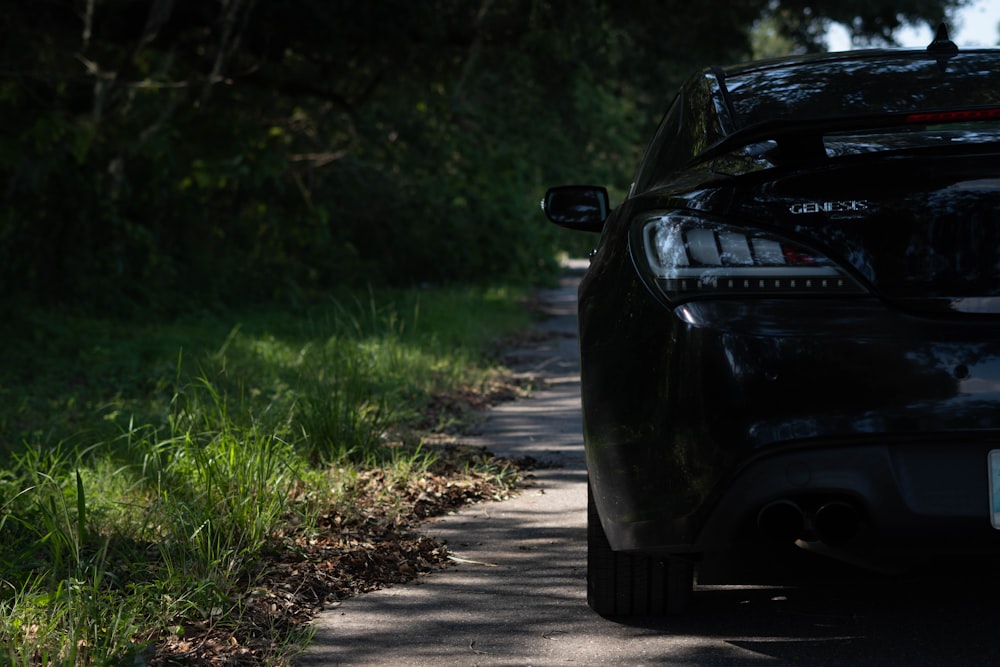 a black car parked on the side of a road