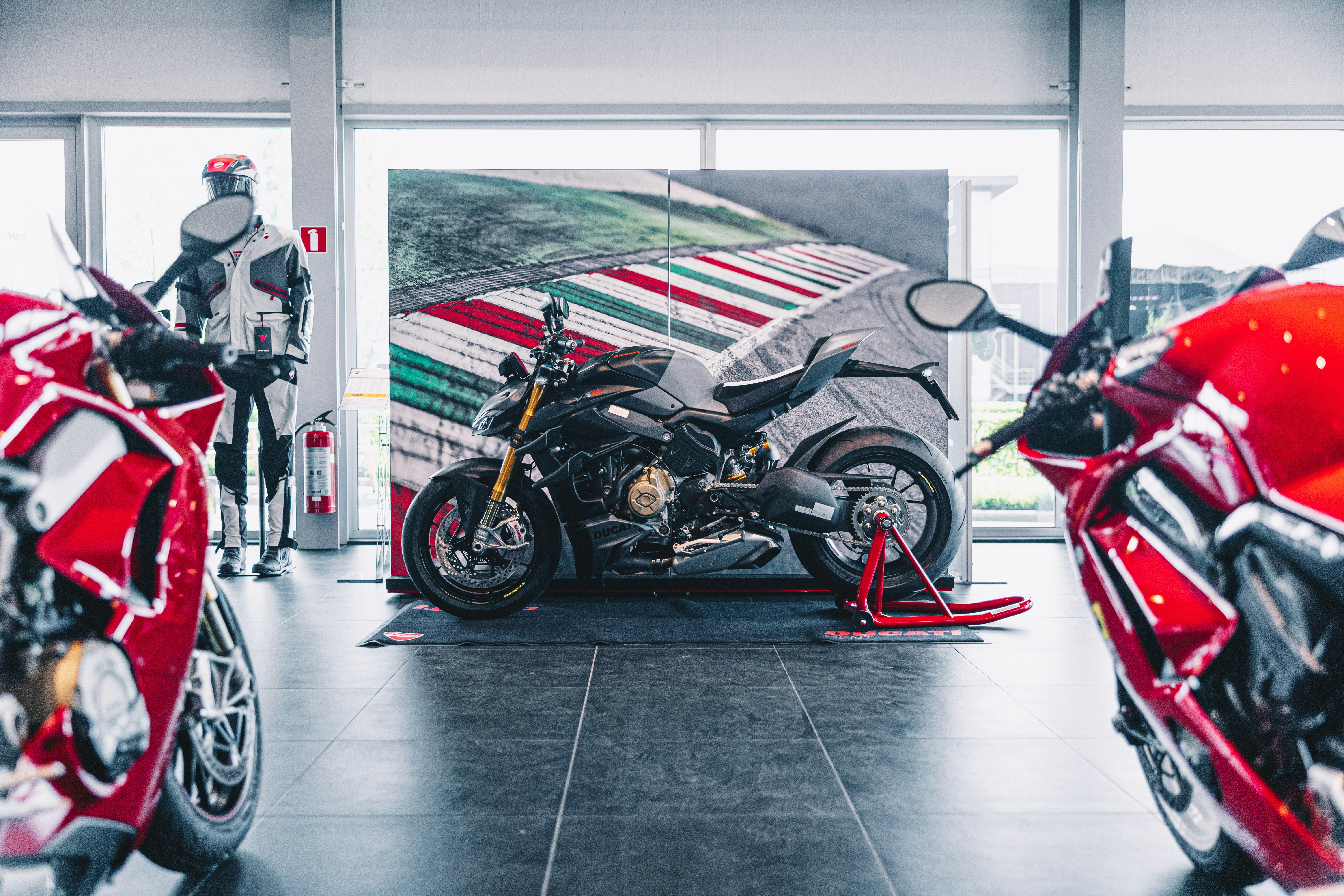 a red motorcycle is parked in a garage