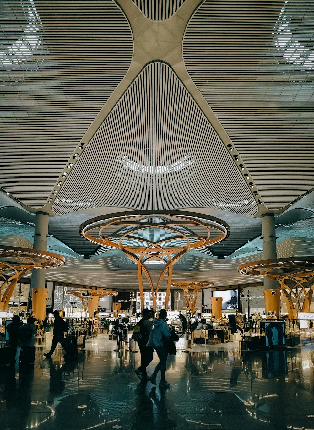 a couple of people are walking through an airport