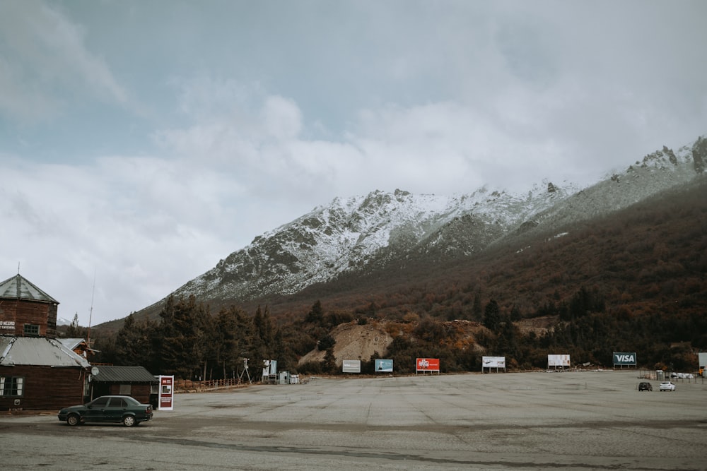 a car parked in a parking lot in front of a mountain
